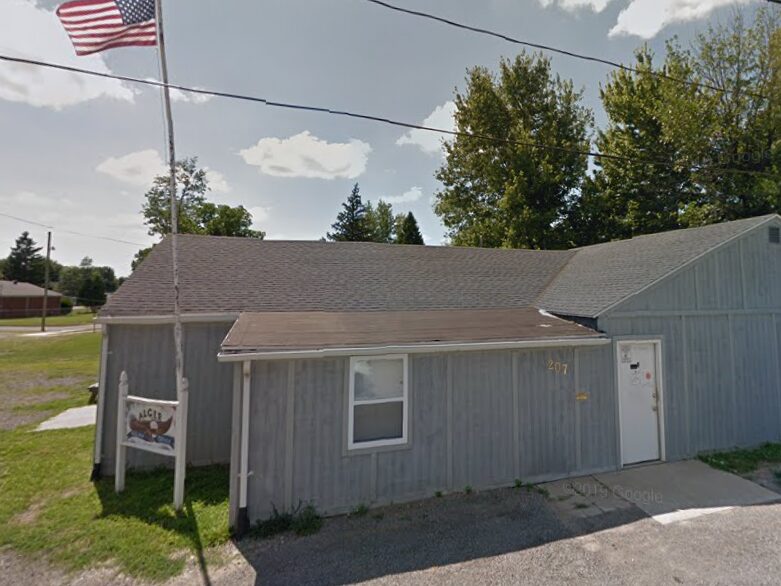 Village of Alger Office at 207 Angle Street with the American flag flying.